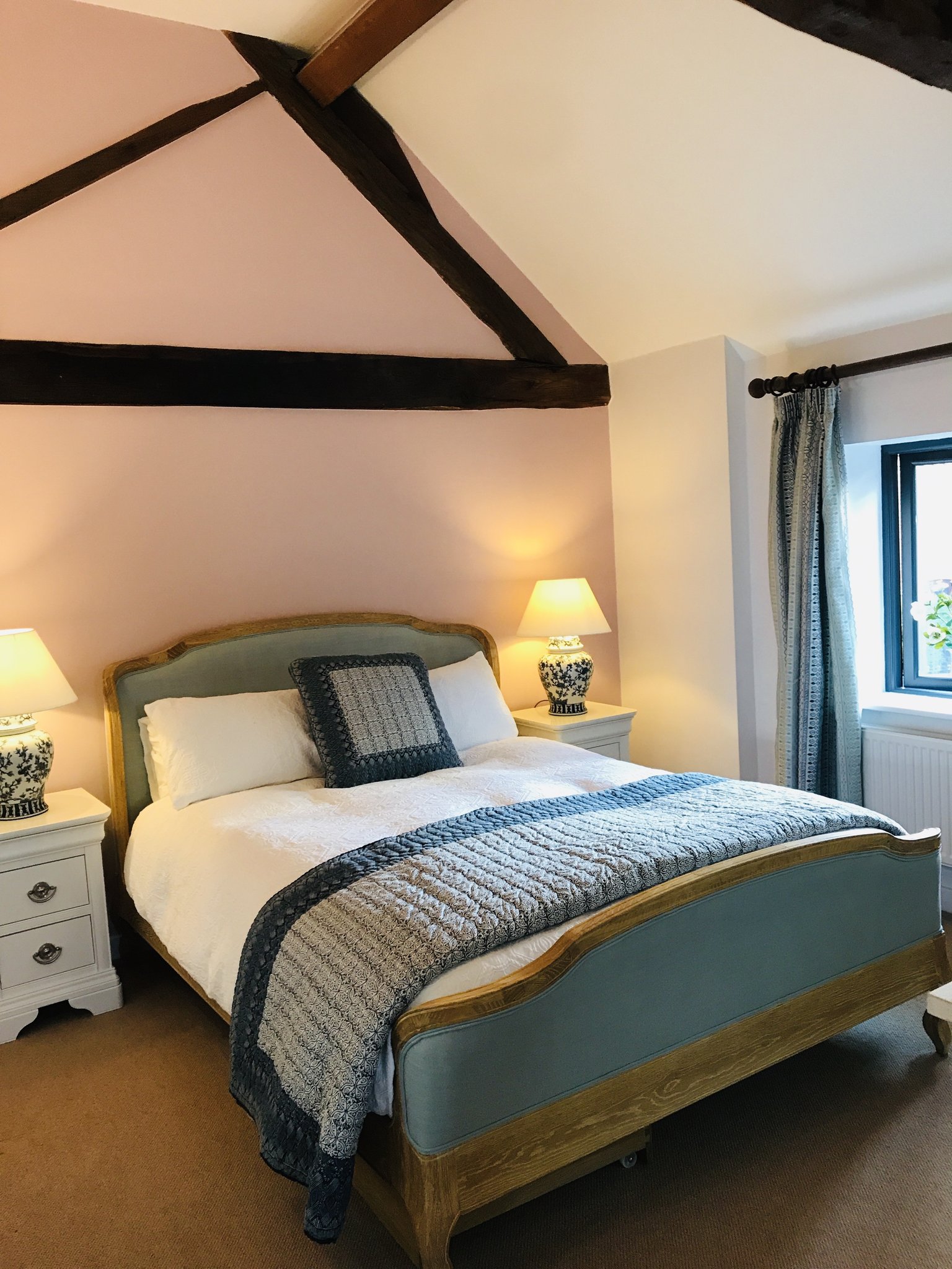 Beamed cottage bedroom in soft blush