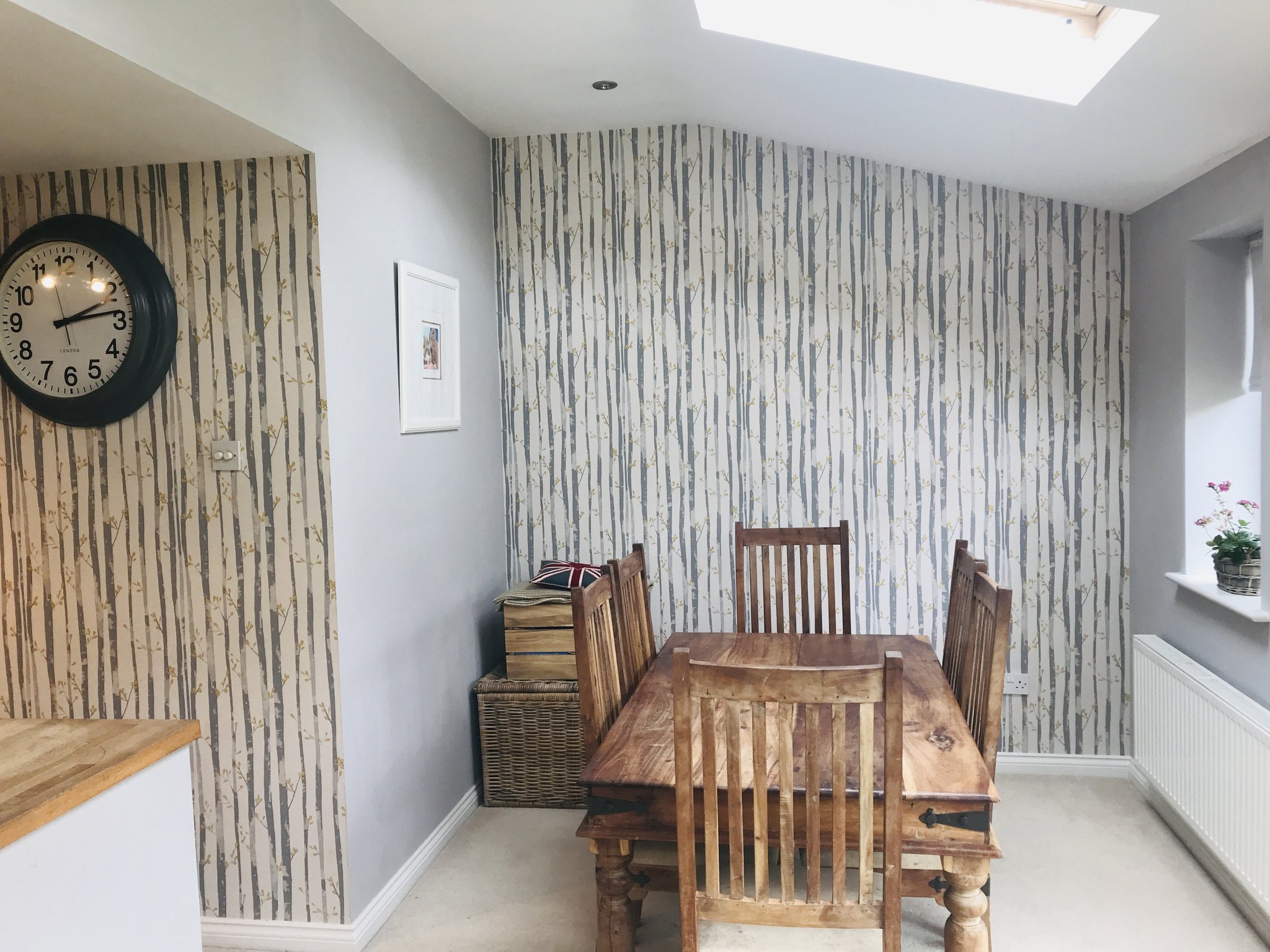 Dining area with birch-tree feature wallpaper