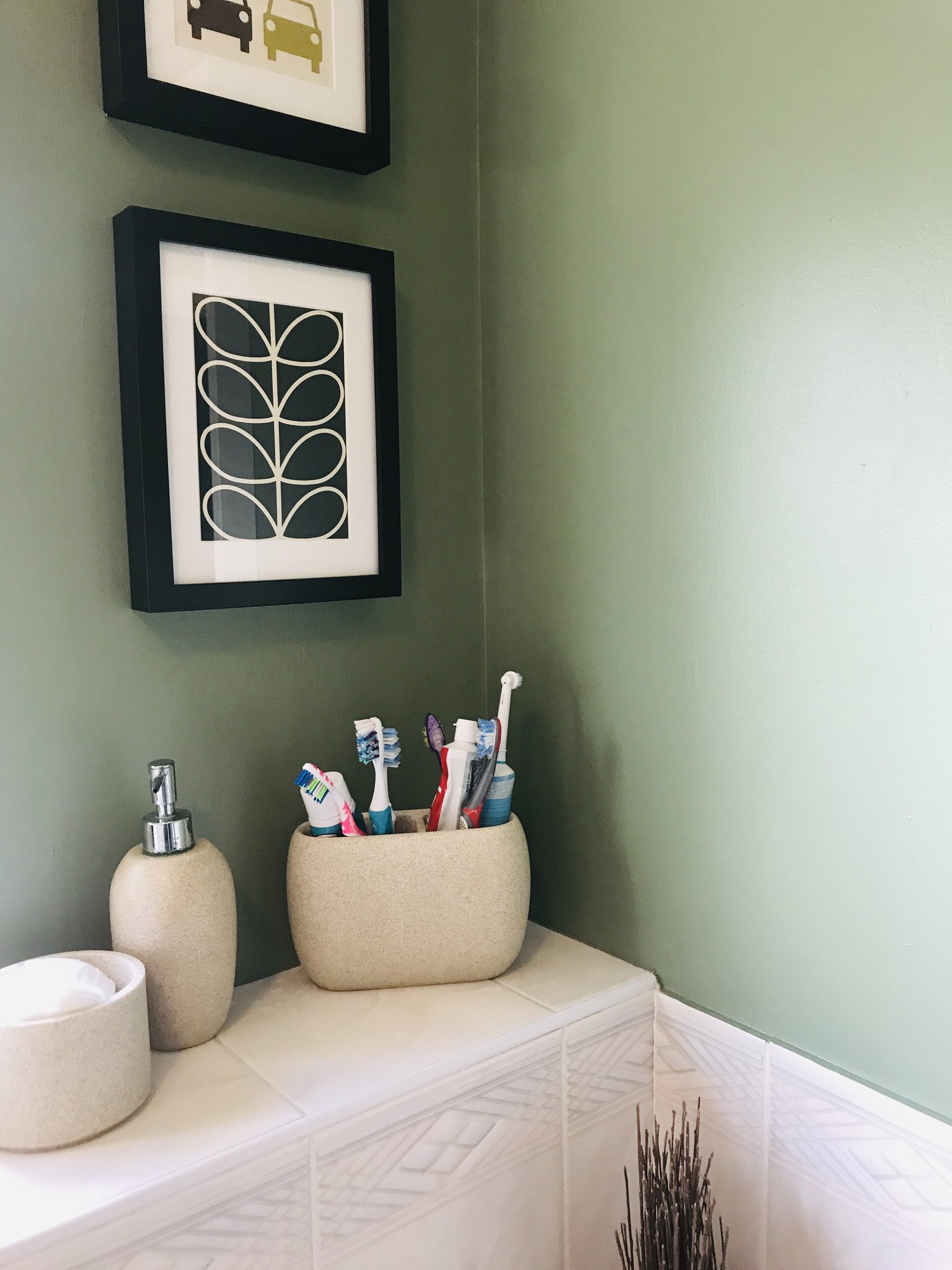 Bathroom wall painted in soft sage green