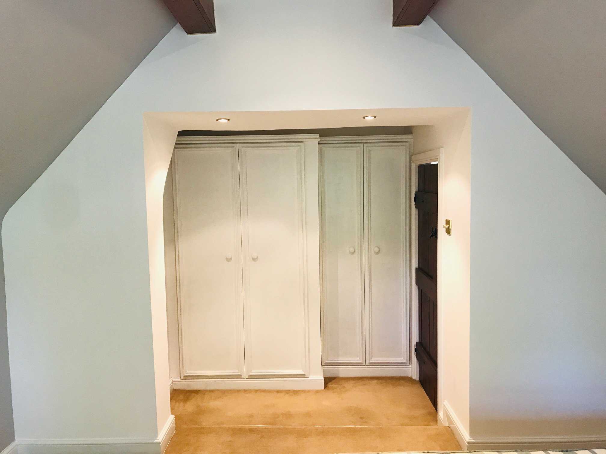 Attic built-in wardrobes painted white